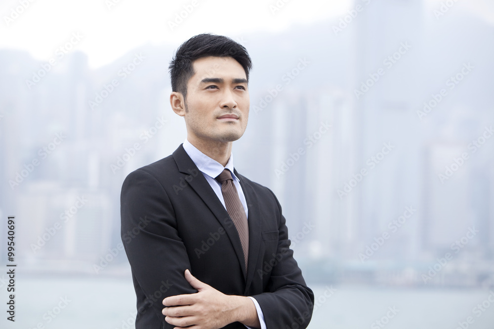 Professional businessman arms crossed, Hong Kong Professional businessman arms crossed, Hong Kong
