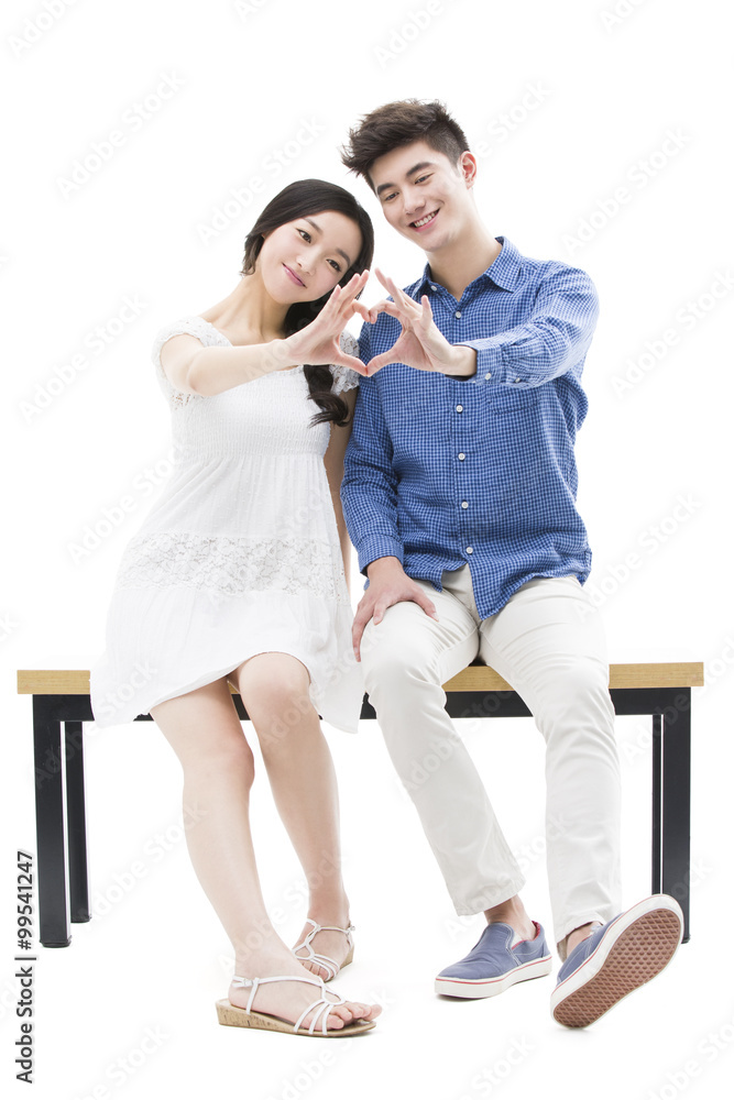 Young couple making heart shape with their hands Young couple making heart shape with their hands