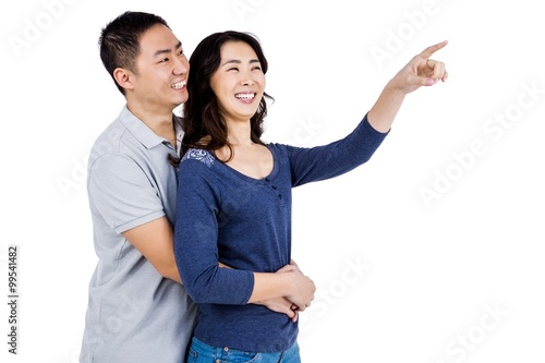 Happy couple with woman pointing up