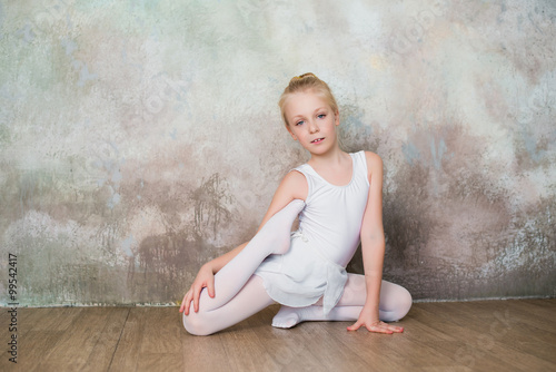 Little girl dancer doing stretching before exercise, dance, sports, healthy lifestyle