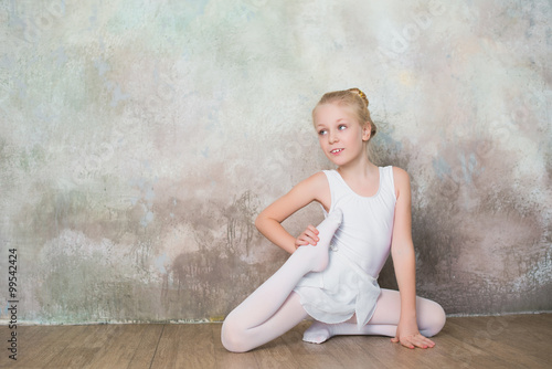 Little girl dancer doing stretching before exercise, dance, sports, healthy lifestyle