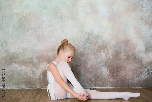 Little girl dancer doing stretching before exercise, dance, sports, healthy lifestyle