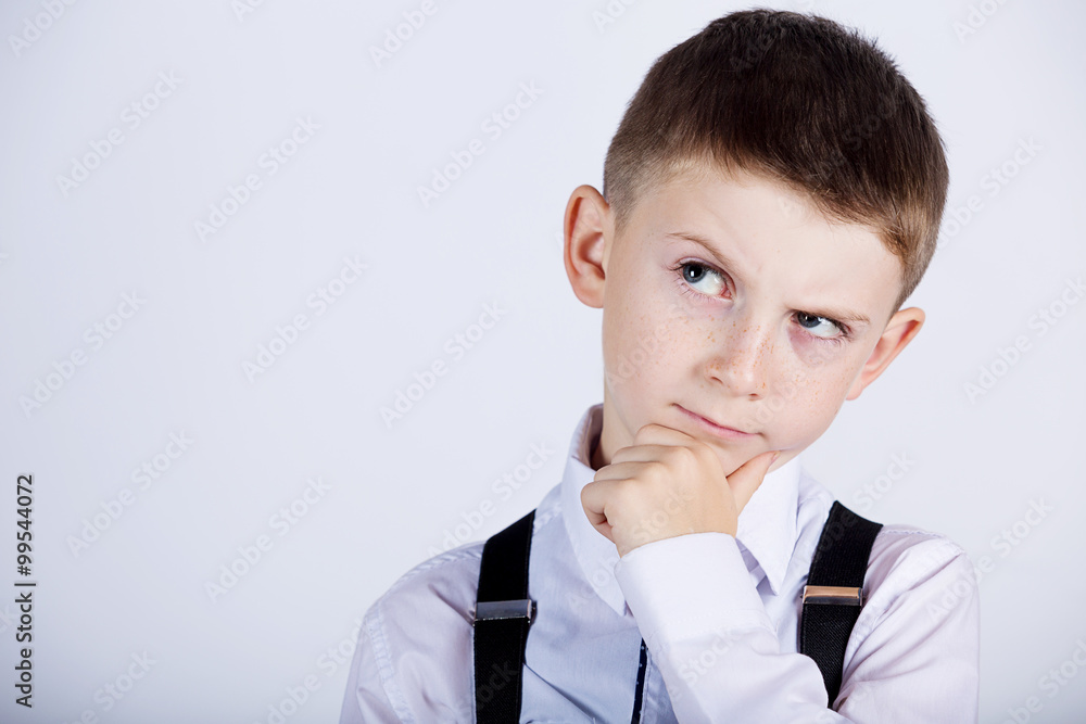 Thinking child-Portrait of a little boy thinking deeply about something with hand on chin looking to camera. Thinking child-Portrait of a little boy thinking deeply about something with hand on chin looking to camera.