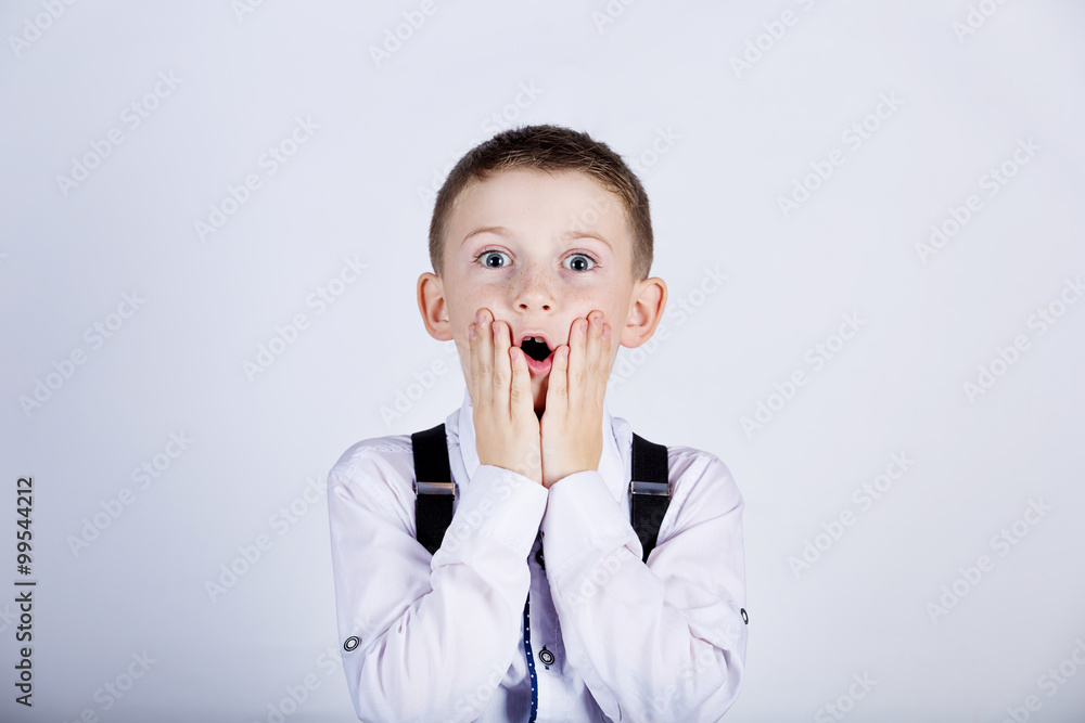 Surprised little boy holding hands on his face isolated over white background. Surprised little boy holding hands on his face isolated over white background.