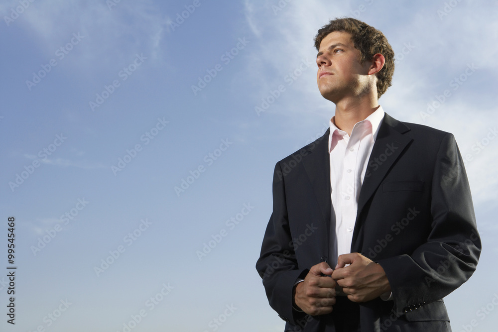 Man Standing In Field, Looking Into The Distance Man Standing In Field, Looking Into The Distance