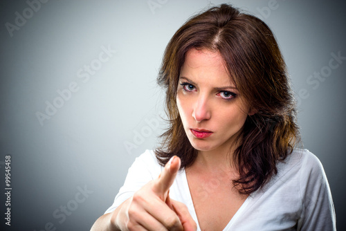 Young woman pointing a finger of blame photo