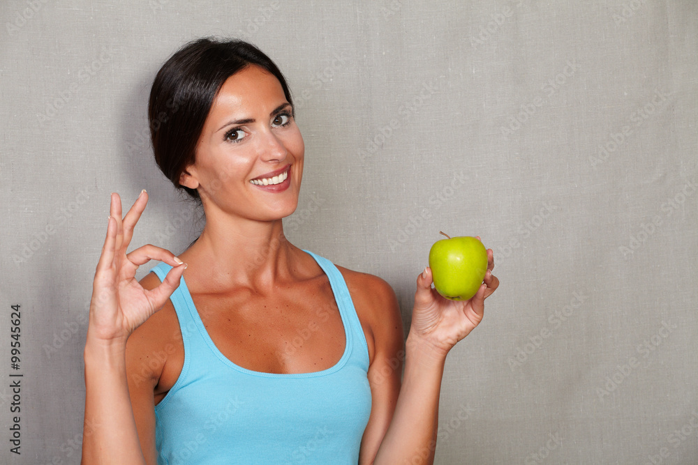 Satisfied lady showing ok sign and toothy smile Satisfied lady showing ok sign and toothy smile