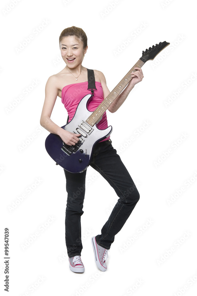 Fototapeta premium Young woman playing an electric guitar