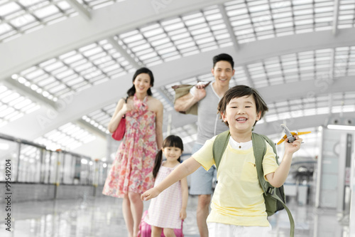 Happy family with luggage at the airport
