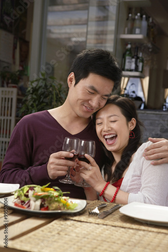 Young Couple Making A Toast At A Meal