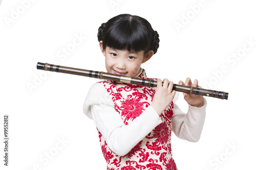 Happy girl playing traditional Chinese flute