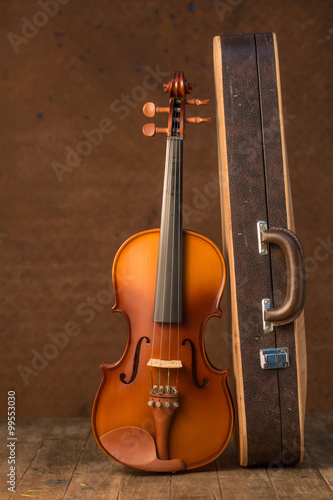 Vintage violin and case with old steel background