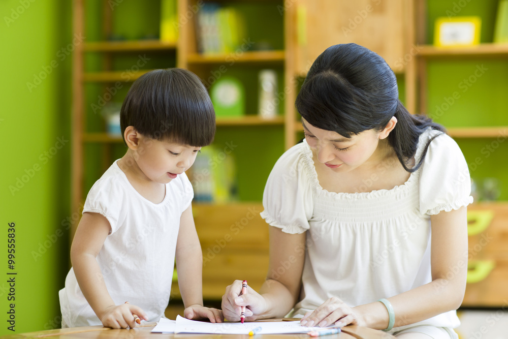 Mother and daughter practicing drawing Mother and daughter practicing drawing