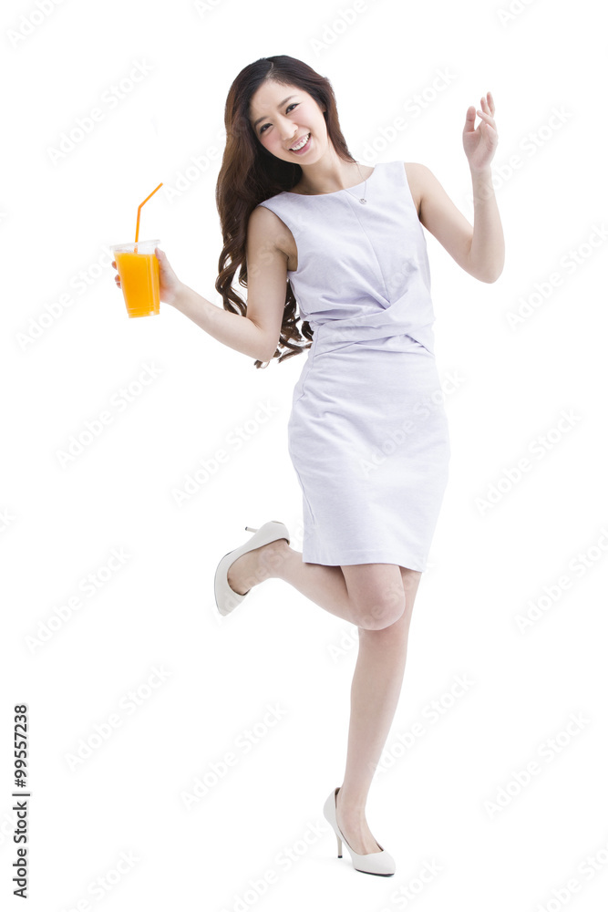 Portrait of beautiful young woman holding a cup of juice