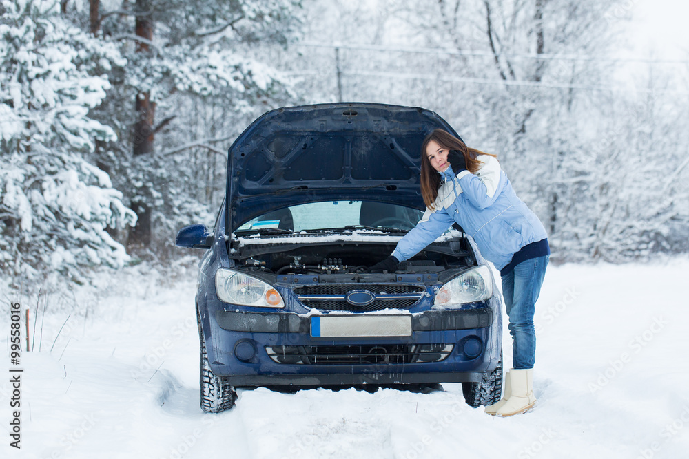 Winter car breakdown - woman call for help.