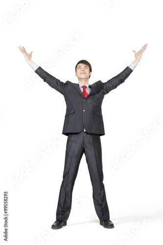 Young businessman with his arms extended