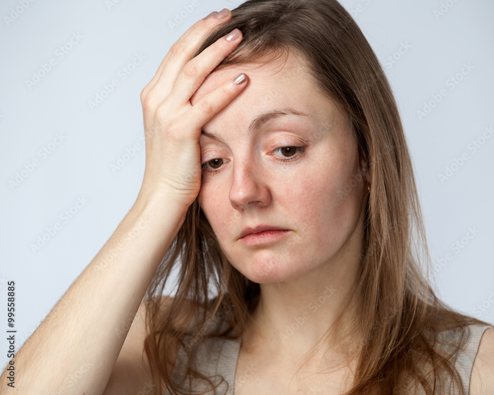 Portrait of a sad woman, hand on the forehead Portrait of a sad woman, hand on the forehead