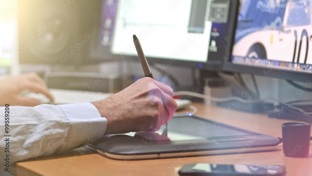 custom made wallpaper toronto digitalGraphic Designer working with digital Drawing tablet and Pen on a computer. Smooth tracking shot with nice backlit lensflare.
