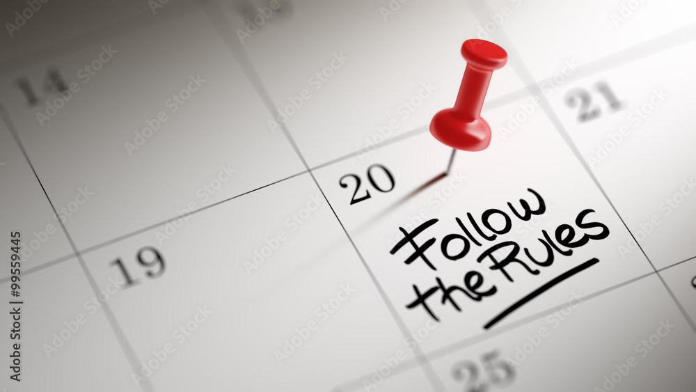 Concept image of a Calendar with a red push pin. Closeup shot of