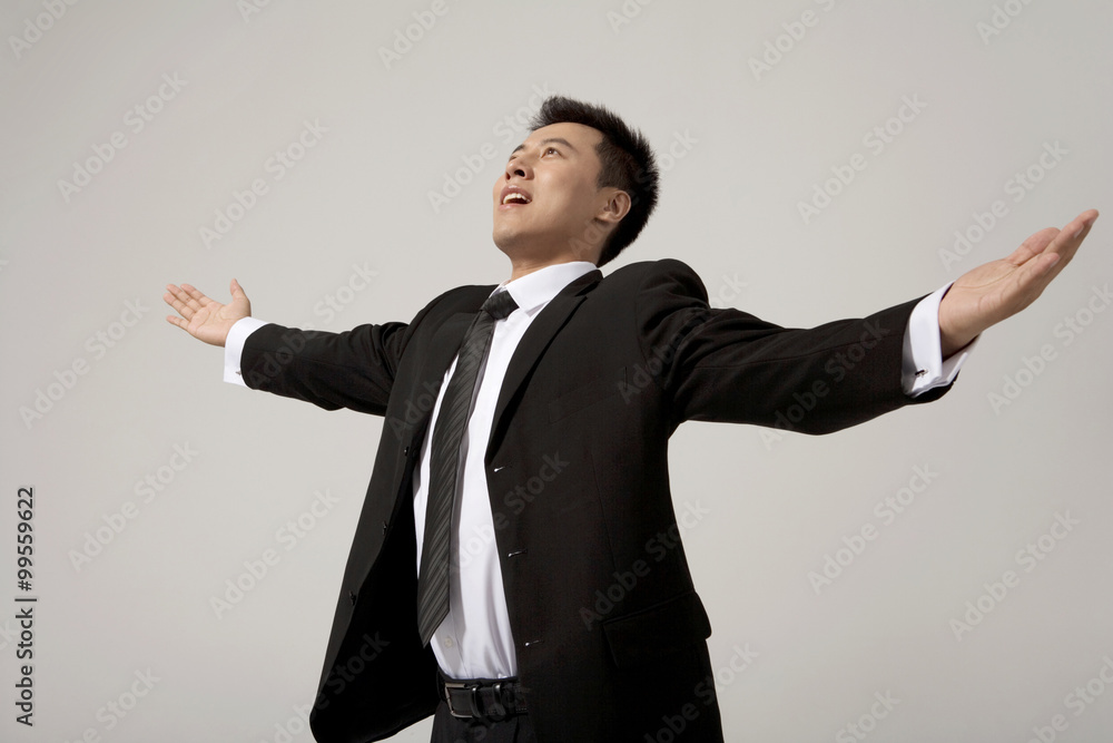 A businessman with his hands held out wide A businessman with his hands held out wide