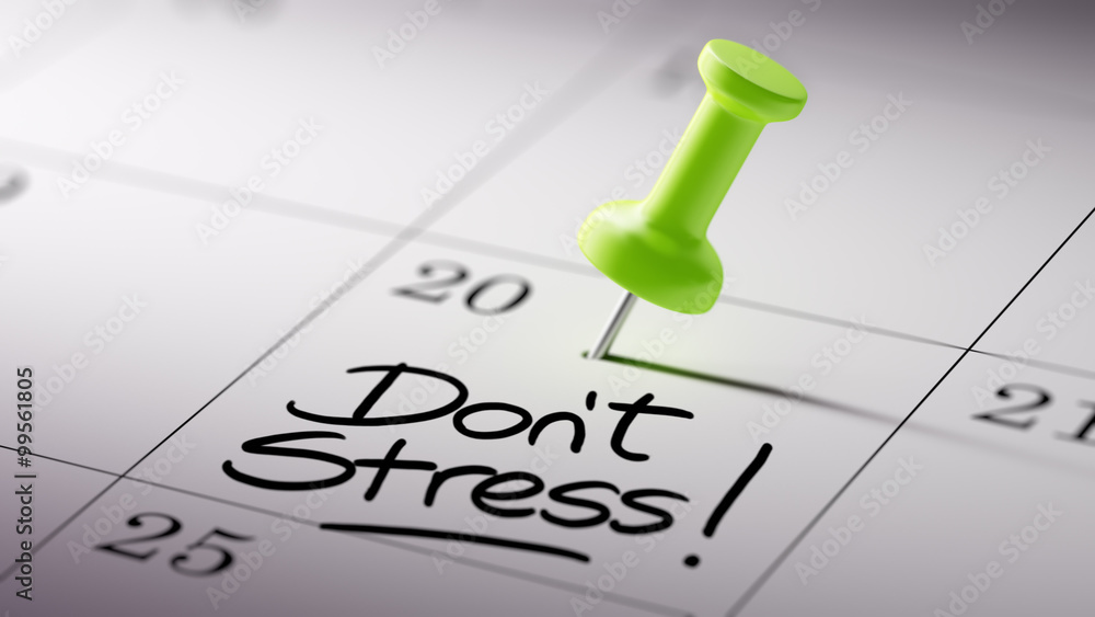 Concept image of a Calendar with a green push pin. Closeup shot