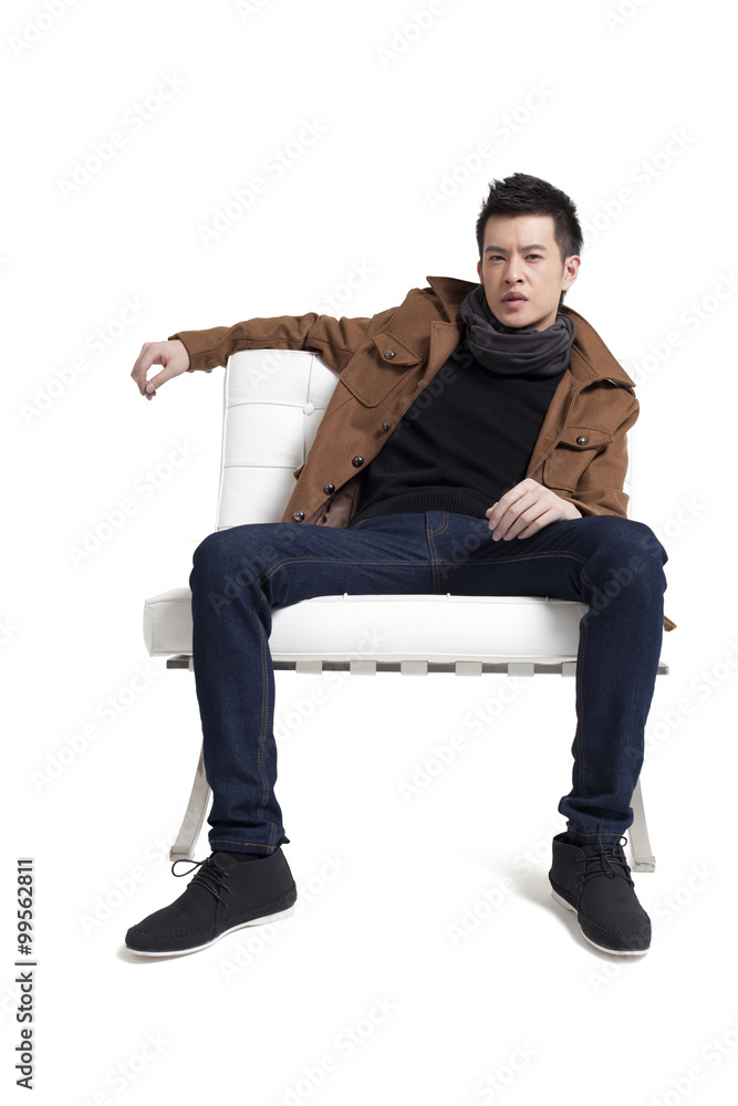 Stylish young man sitting on a chair