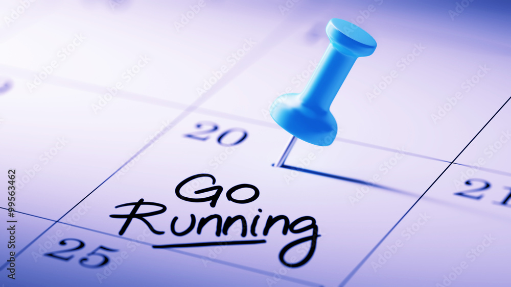 Concept image of a Calendar with a blue push pin. Closeup shot o Concept image of a Calendar with a blue push pin. Closeup shot o
