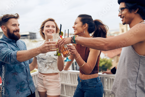 Friends enjoying cocktails at a rooftop party