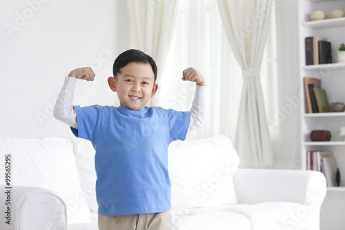Chinese boy flexing muscles