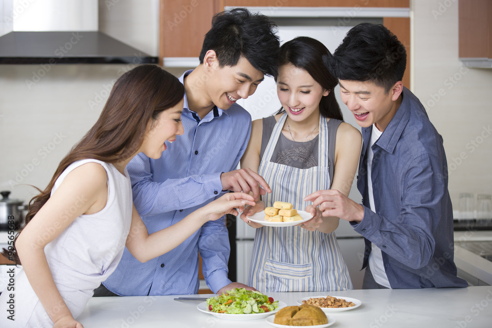 Young woman cooking for her friends in the kitchen Young woman cooking for her friends in the kitchen