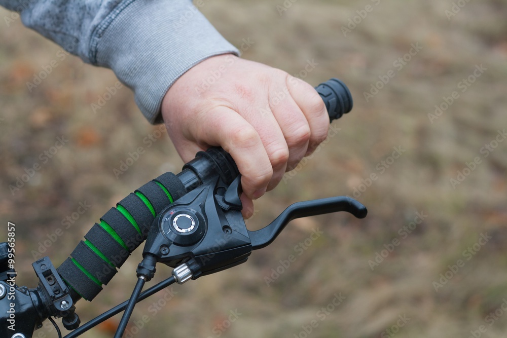 the male strong hand holds a bicycle wheel the male strong hand holds a bicycle wheel