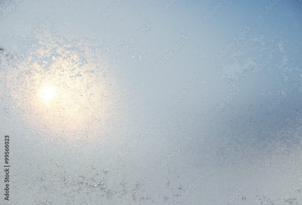 Frozen white window covered with frost in winter patterned. Frozen white window covered with frost in winter patterned.