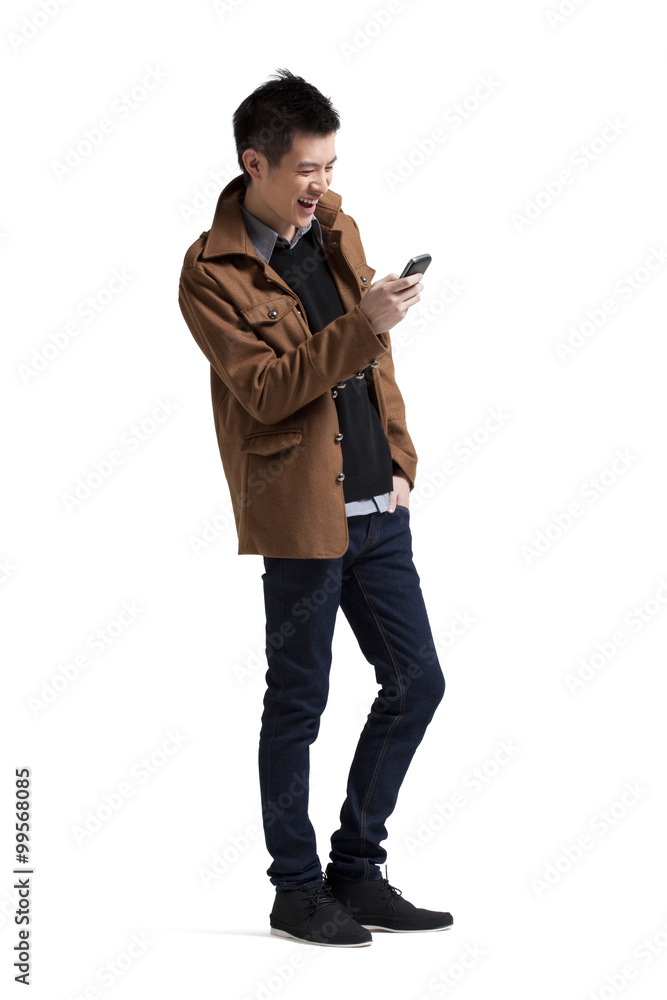 Fototapeta premium Young man using mobile phone