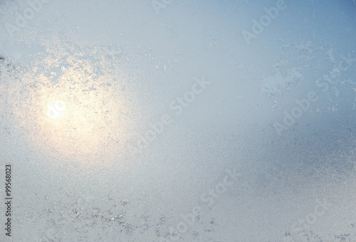 Frozen white window covered with frost in winter patterned. photo