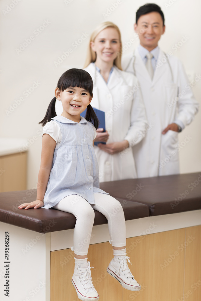 Fototapeta premium Happy girl sitting on examination table