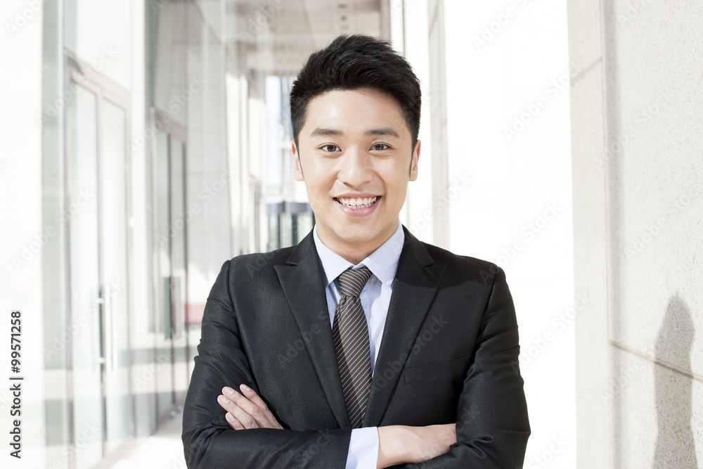 Portrait of confident young businessman in downtown district Portrait of confident young businessman in downtown district