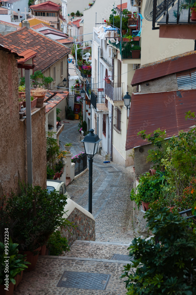 Narrow street and stairs between cute italian houses in old town of Scilla