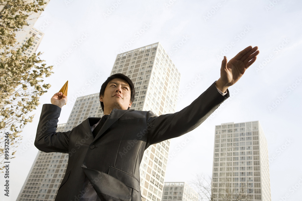 Businessman throwing paper airplane Businessman throwing paper airplane