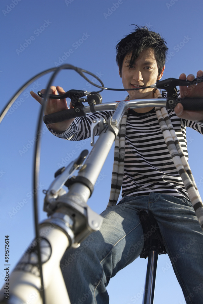 Young Man Riding Bicycle