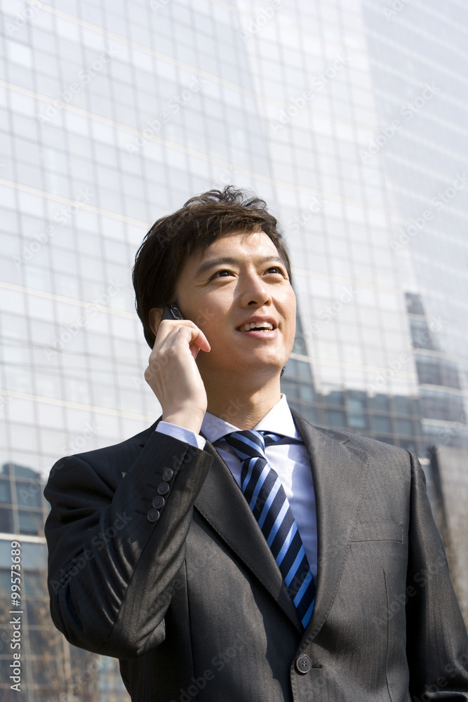 Businessman on the phone outside a building Businessman on the phone outside a building