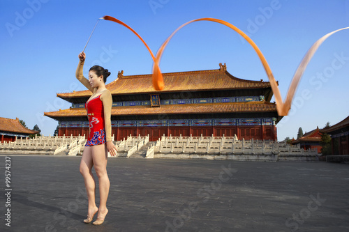 Young Woman Ribbon Dancing In Front Of A Temple photo