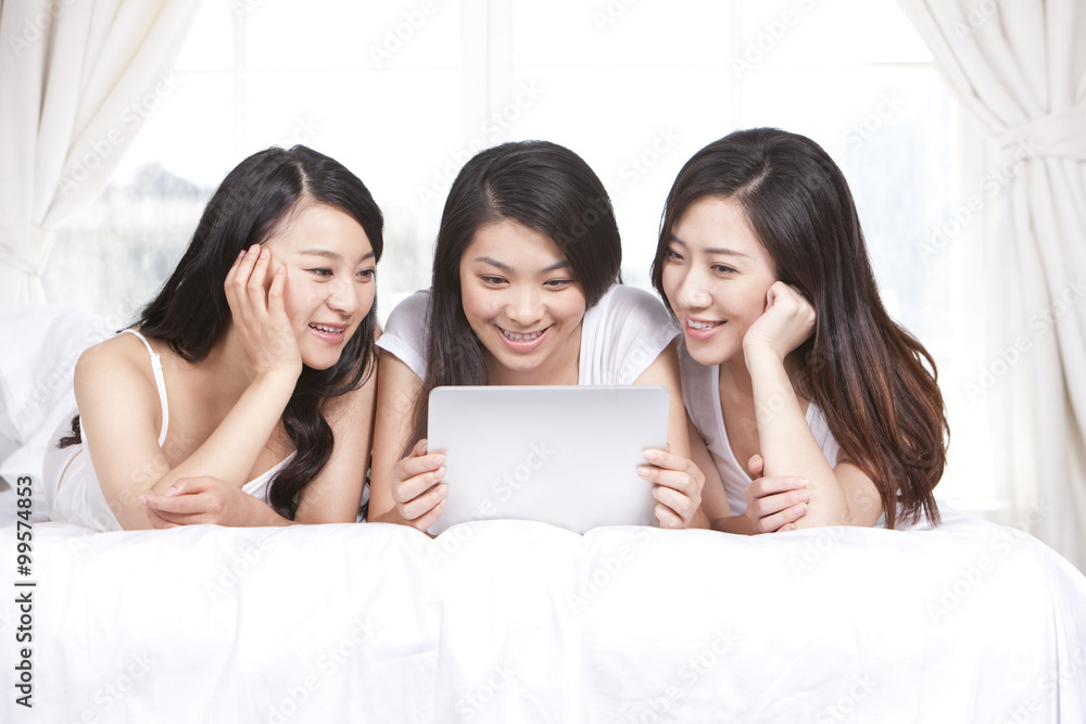 Best female friends using digital tablet at home Best female friends using digital tablet at home