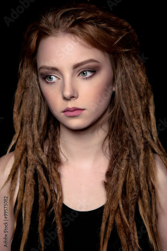 Wallpaper Mural Sad Beautiful Young woman student with dreadlocks on black background - Stock Image Torontodigital.ca