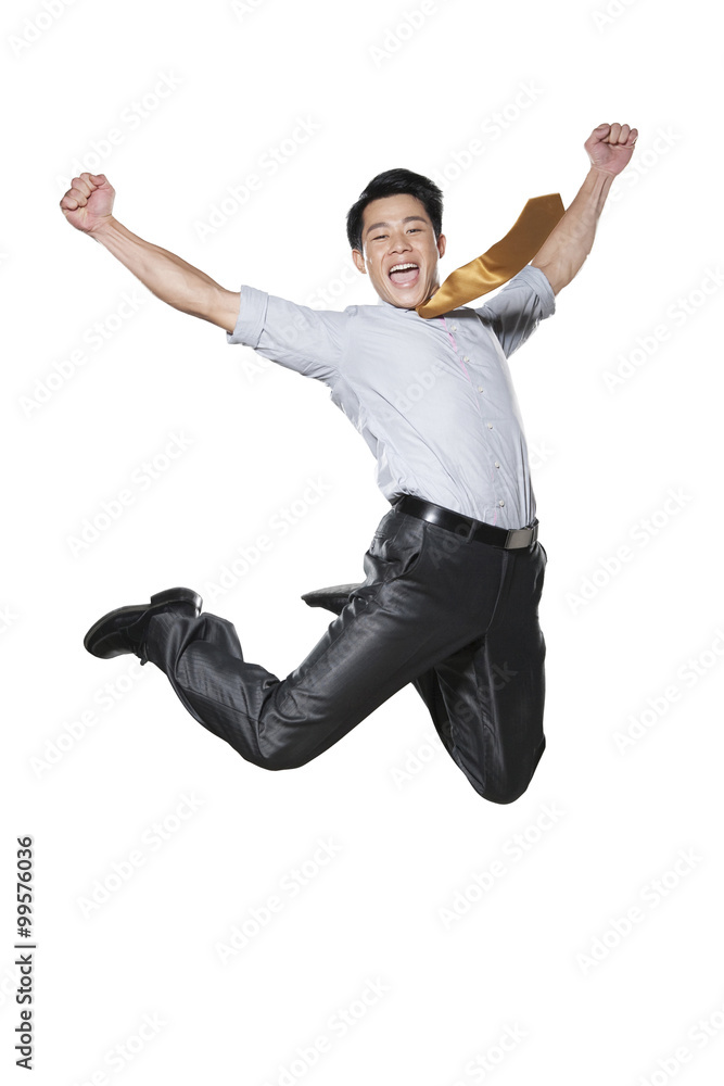 Businessman jumping in the air in celebration