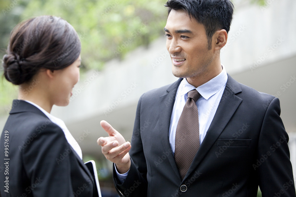 Cheerful business partners talking face to face, Hong Kong Cheerful business partners talking face to face, Hong Kong