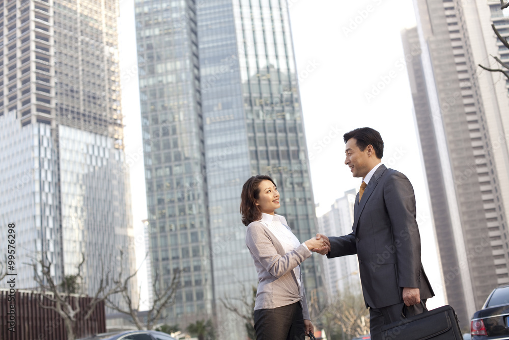 Businesspeople shaking hands in the financial district Businesspeople shaking hands in the financial district