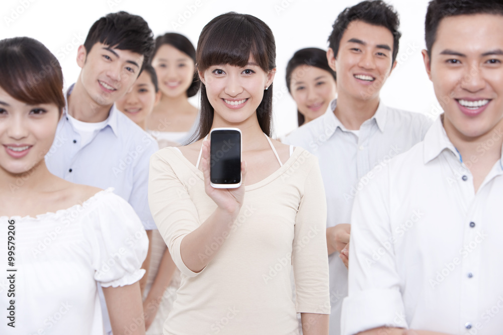 Portrait of young woman showing mobile phone with friends around Portrait of young woman showing mobile phone with friends around