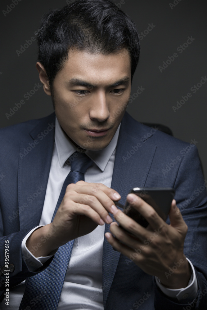 Confident businessman using smart phone Confident businessman using smart phone