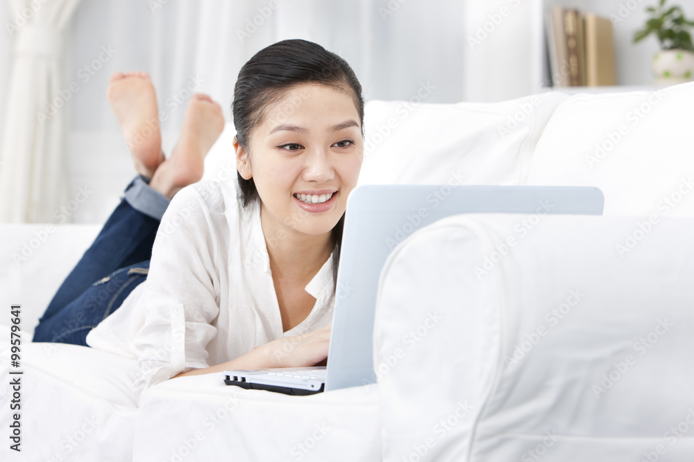 Young woman using laptop at home Young woman using laptop at home
