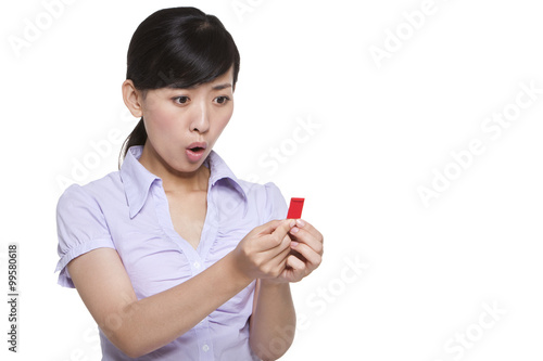 Surprised Woman Looking at a Small Chinese New Year Envelope